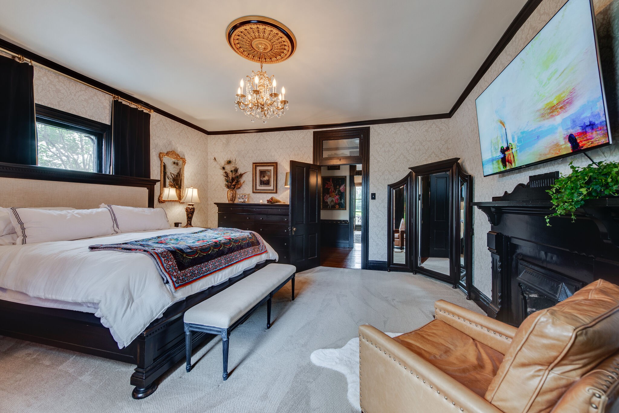 607 5th Avenue West Springfield, TN 37172 - Photo 36 of 50 a spacious bedroom with a bed couch and a chandelier