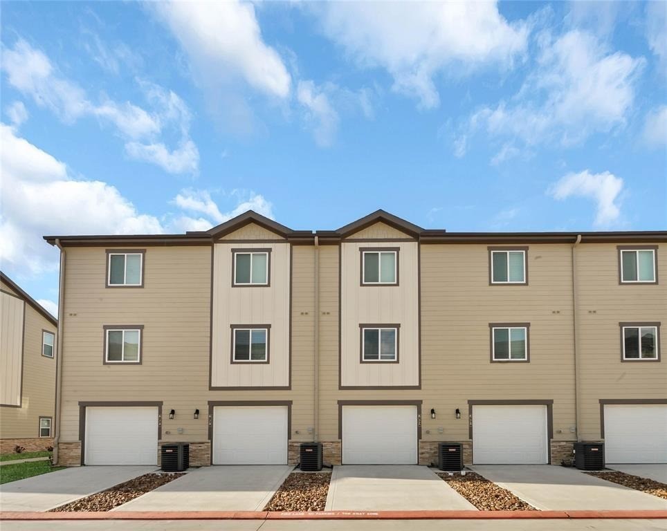 12603 Telge Road, Unit 7D Cypress, TX 77429 - Photo 15 of 19 a front view of a house with a yard