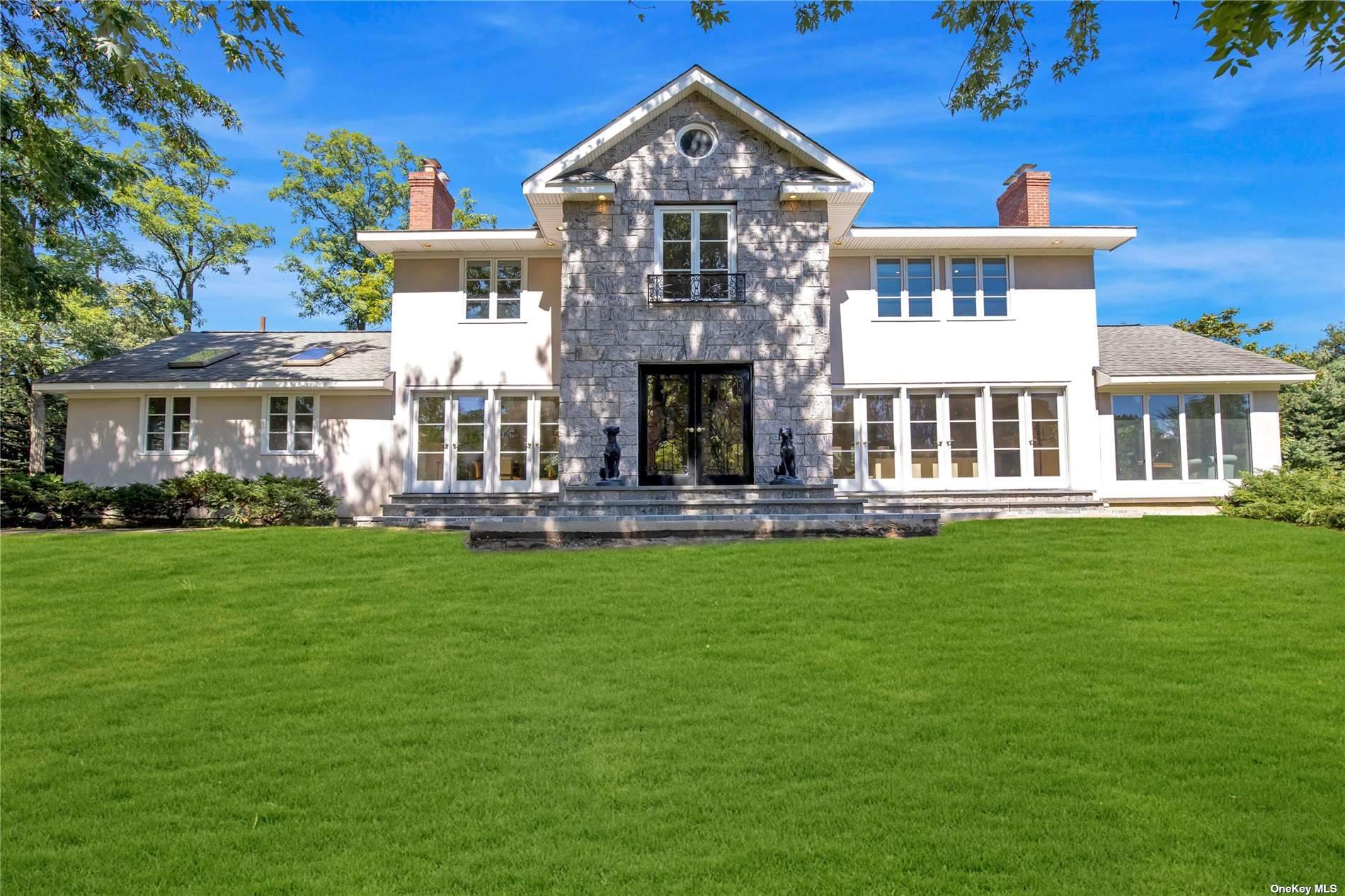 552 Cold Spring Road Laurel Hollow, NY 11791 - Photo 1 of 1 a front view of a house with a garden