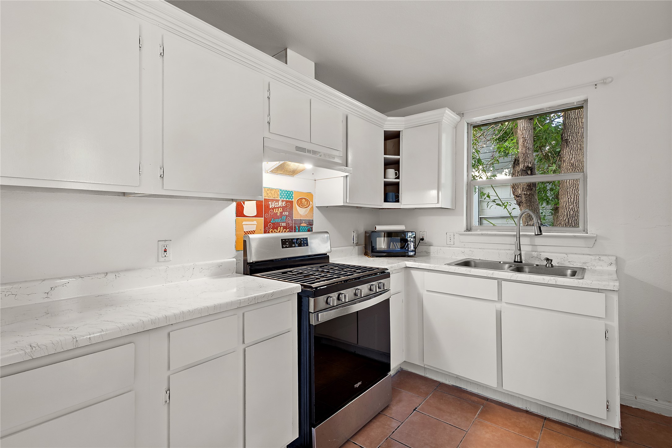 225 Palmyra Street Houston, TX 77022 - Photo 3 of 11 Open-concept kitchen with modern finishes, abundant natural light, and a functional layout that makes cooking and entertaining easy.