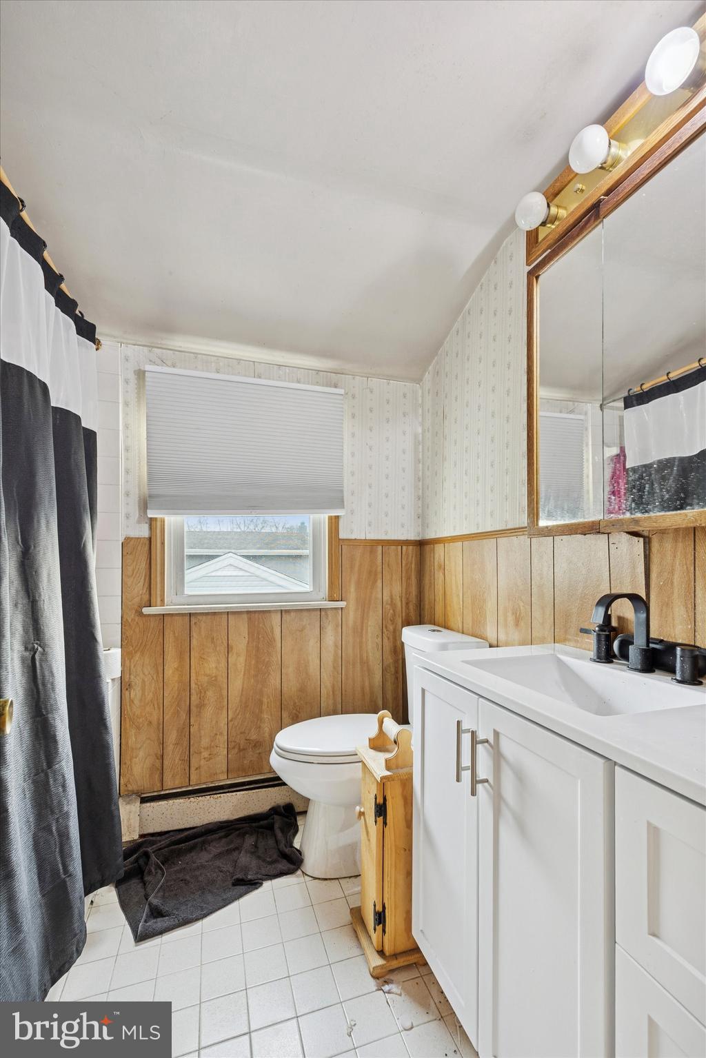 820 Keystone Street Croydon, PA 19021 - Photo 13 of 15 a bathroom with a sink a toilet and a mirror