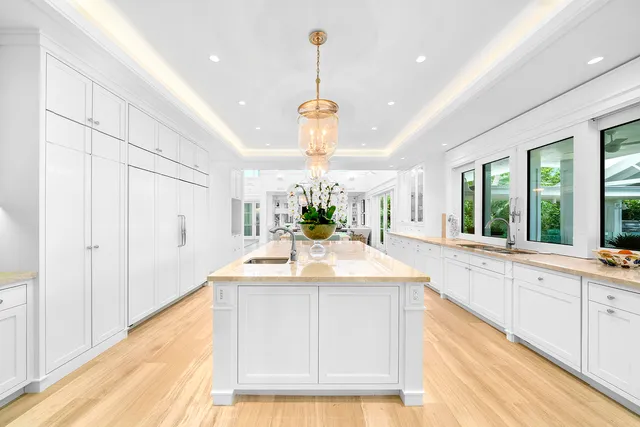 a view of a patio with a table and chairs under an umbrella