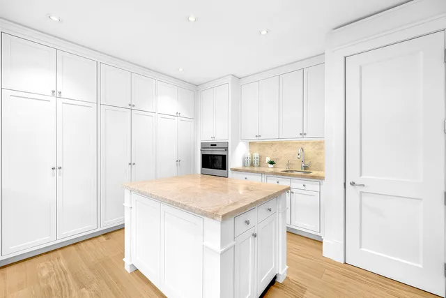 a view of a swimming pool with a table and chairs under an umbrella