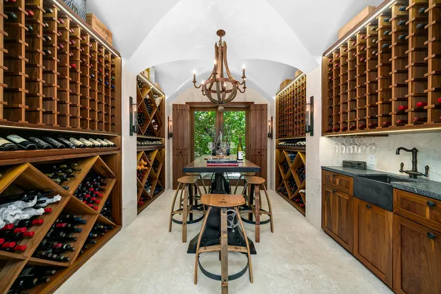 a view of a house with a yard and table and chairs under an umbrella