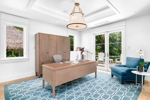 an aerial view of a city with lots of residential buildings and lake view in back