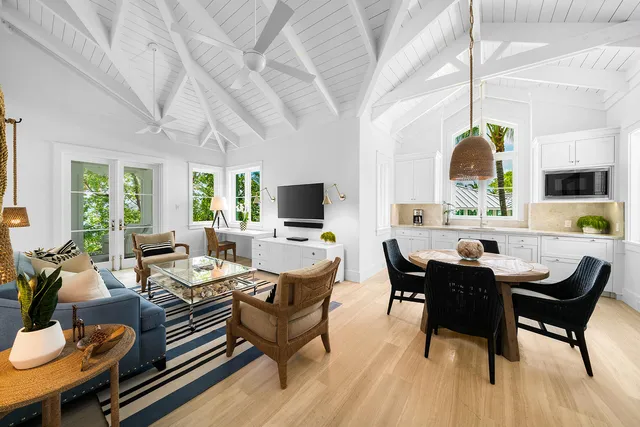 an aerial view of a city with lots of residential buildings and lake in back