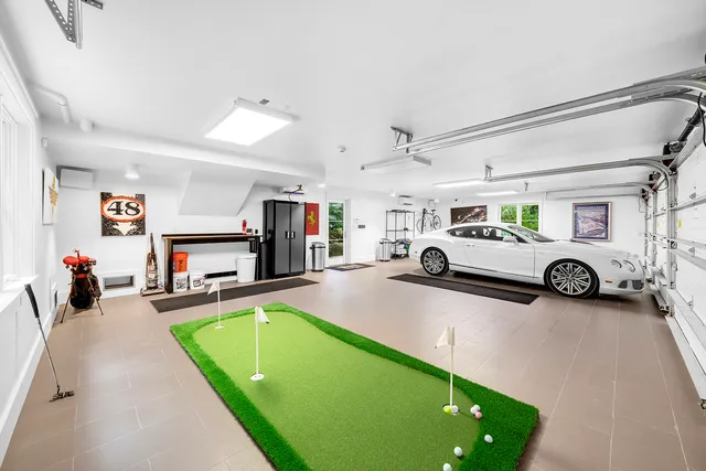 a view of a park with a table and chairs under an umbrella
