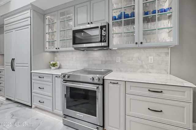 a kitchen with a sink appliances and cabinets