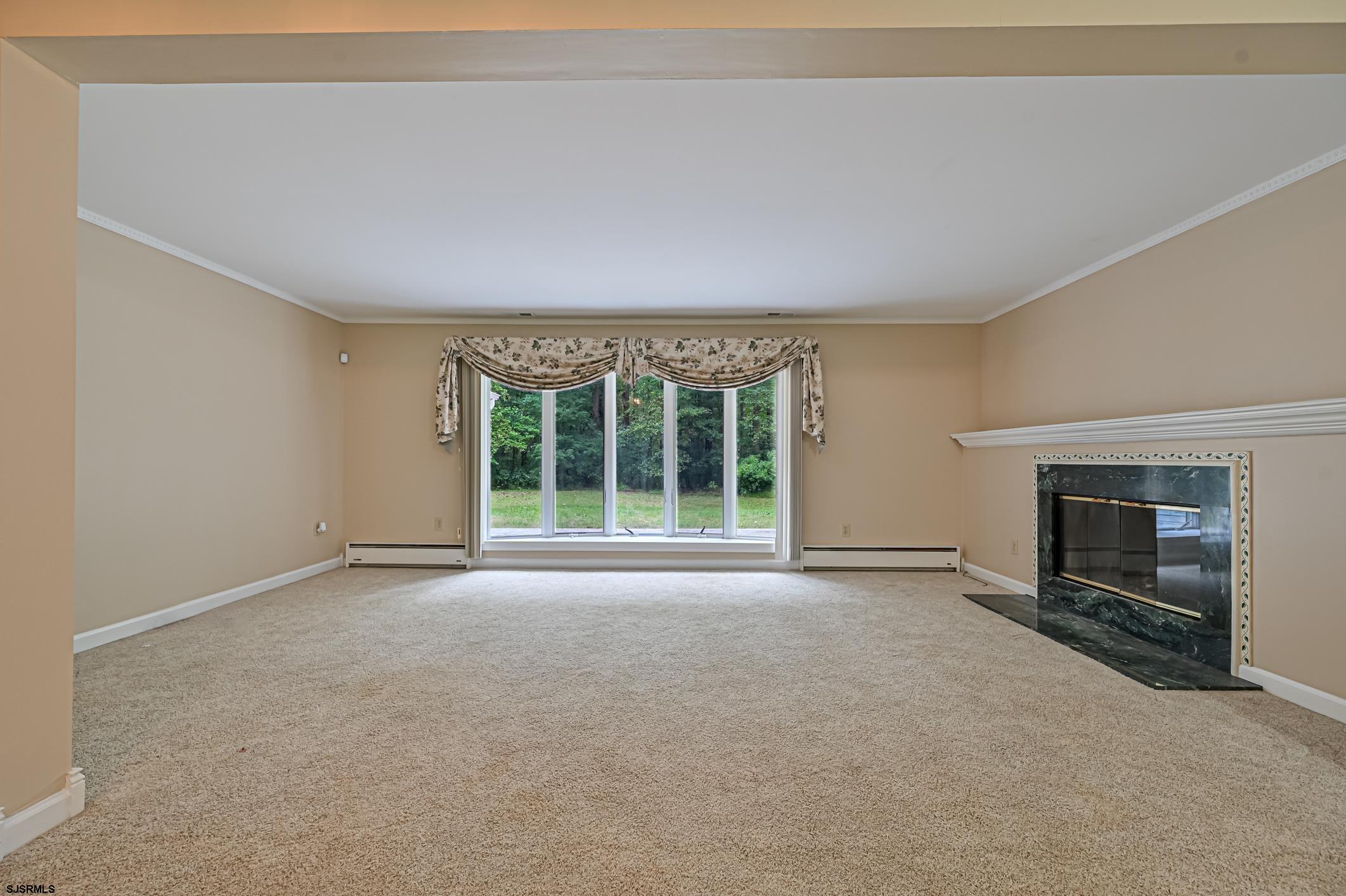 202 Highway 40 Carneys Point, NJ 08069 - Photo 6 of 9 a view of an empty room with a fireplace and a window