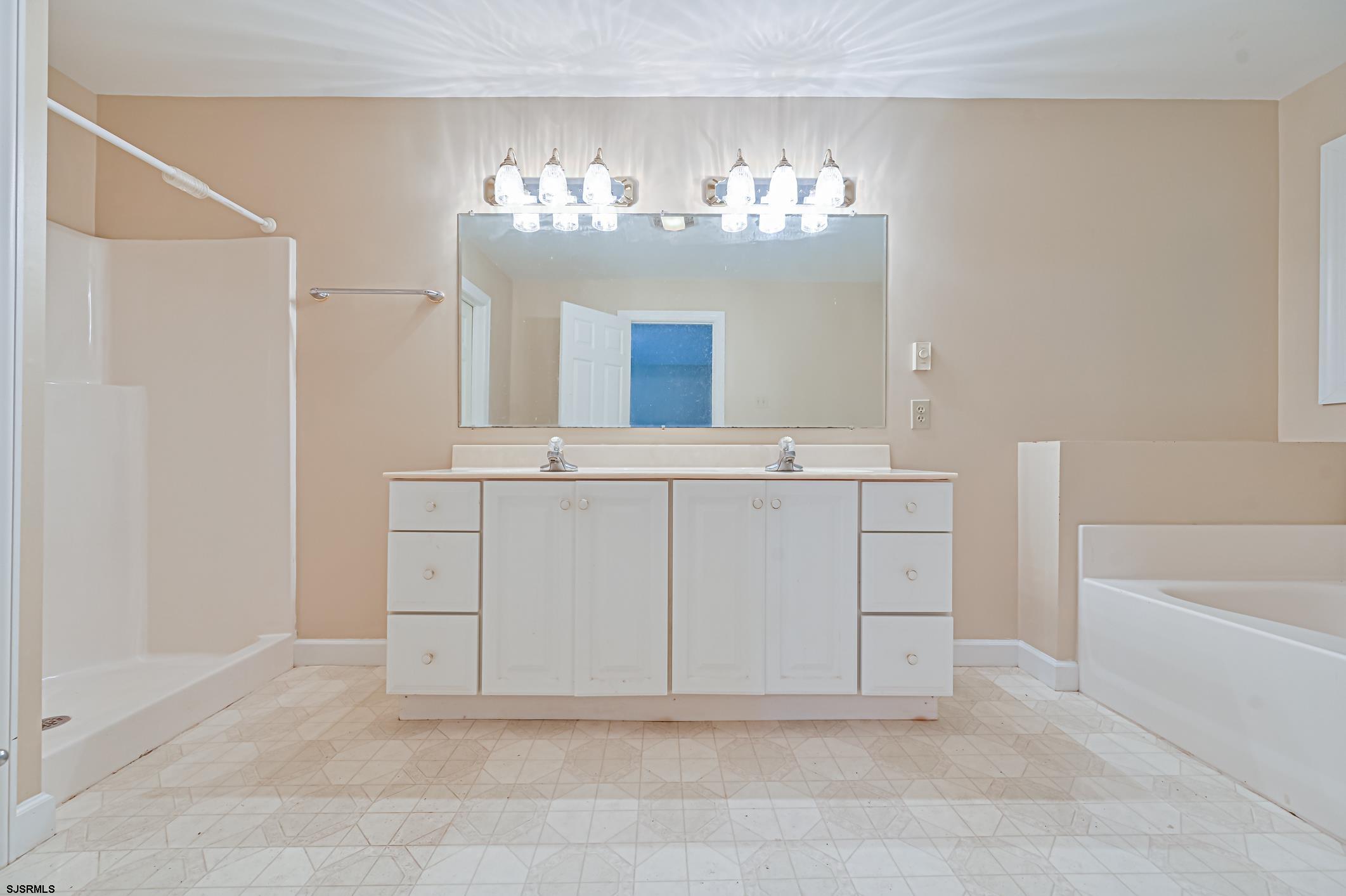 202 Highway 40 Carneys Point, NJ 08069 - Photo 7 of 9 a bathroom with a sink a vanity and a mirror