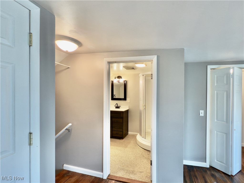 2109 Bell Road Vincent, OH 45784 - Photo 41 of 49 Full bath with vanity, a shower stall, and dark wood-style flooring