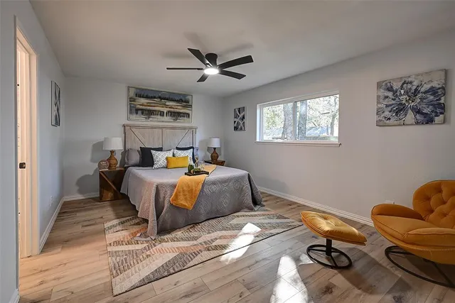 a bedroom with a bed and wooden floor
