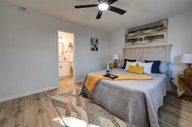 a bedroom with bed and wooden floor