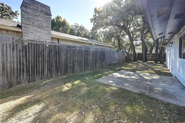 a view of a backyard with wooden fence