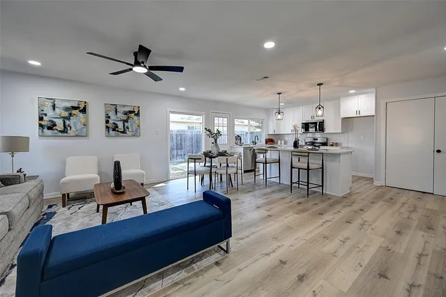 a living room with lots of furniture and kitchen view