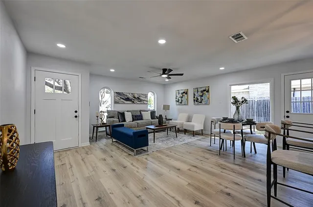 a living room with furniture and a wooden floor