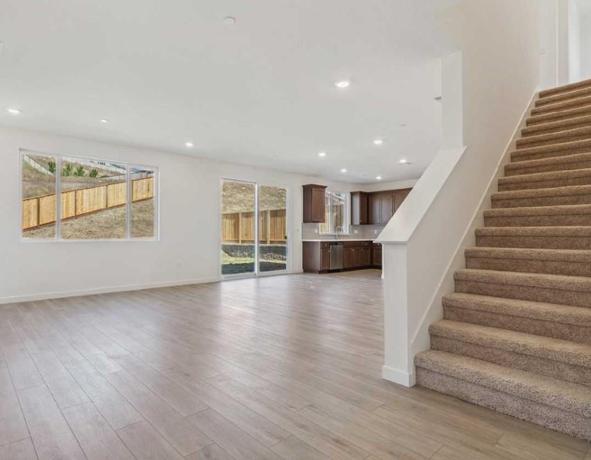 8094 Waterfall Lane Vallejo, CA 94591 - Photo 3 of 13 a view of an empty room with wooden floor and windows