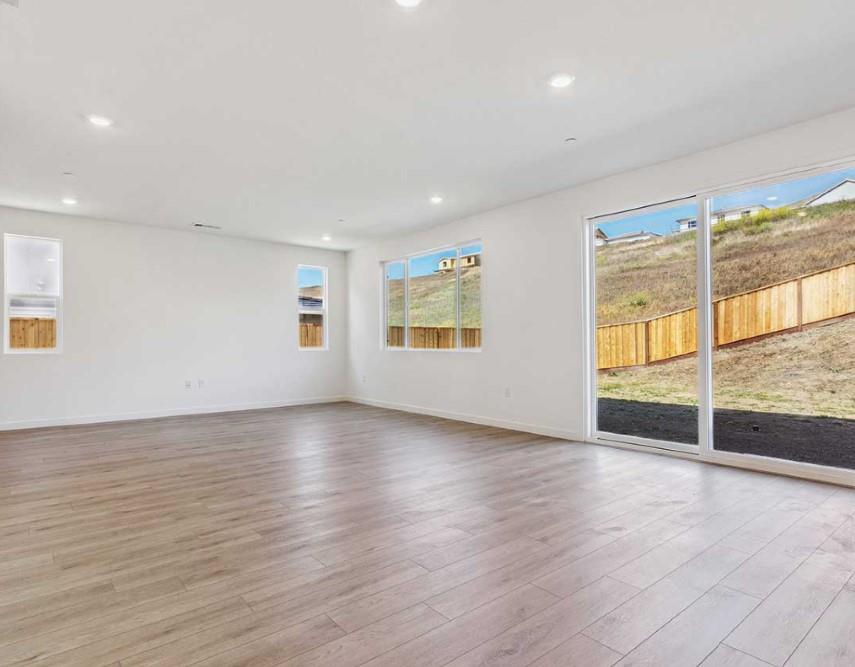 8094 Waterfall Lane Vallejo, CA 94591 - Photo 5 of 13 an empty room with wooden floor and windows