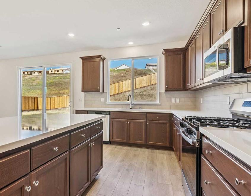 8094 Waterfall Lane Vallejo, CA 94591 - Photo 6 of 13 a kitchen with stainless steel appliances granite countertop a stove a sink and a microwave