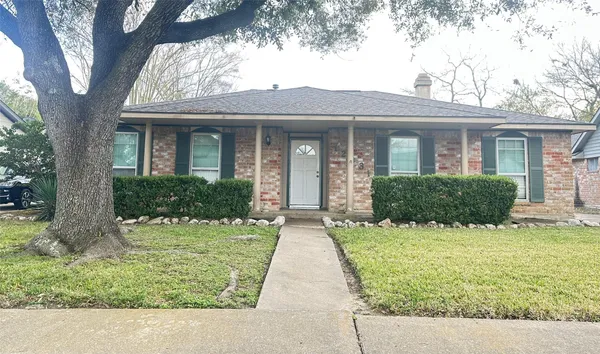 a front view of a house with yard and green space