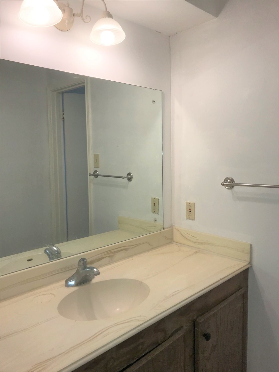 12331 Scarcella Lane Meadows Place, TX 77477 - Photo 11 of 13 A simple vanity with a large mirror and overhead lighting is separate from the shower.