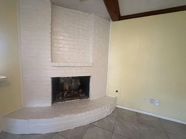 a view of empty room with a fireplace