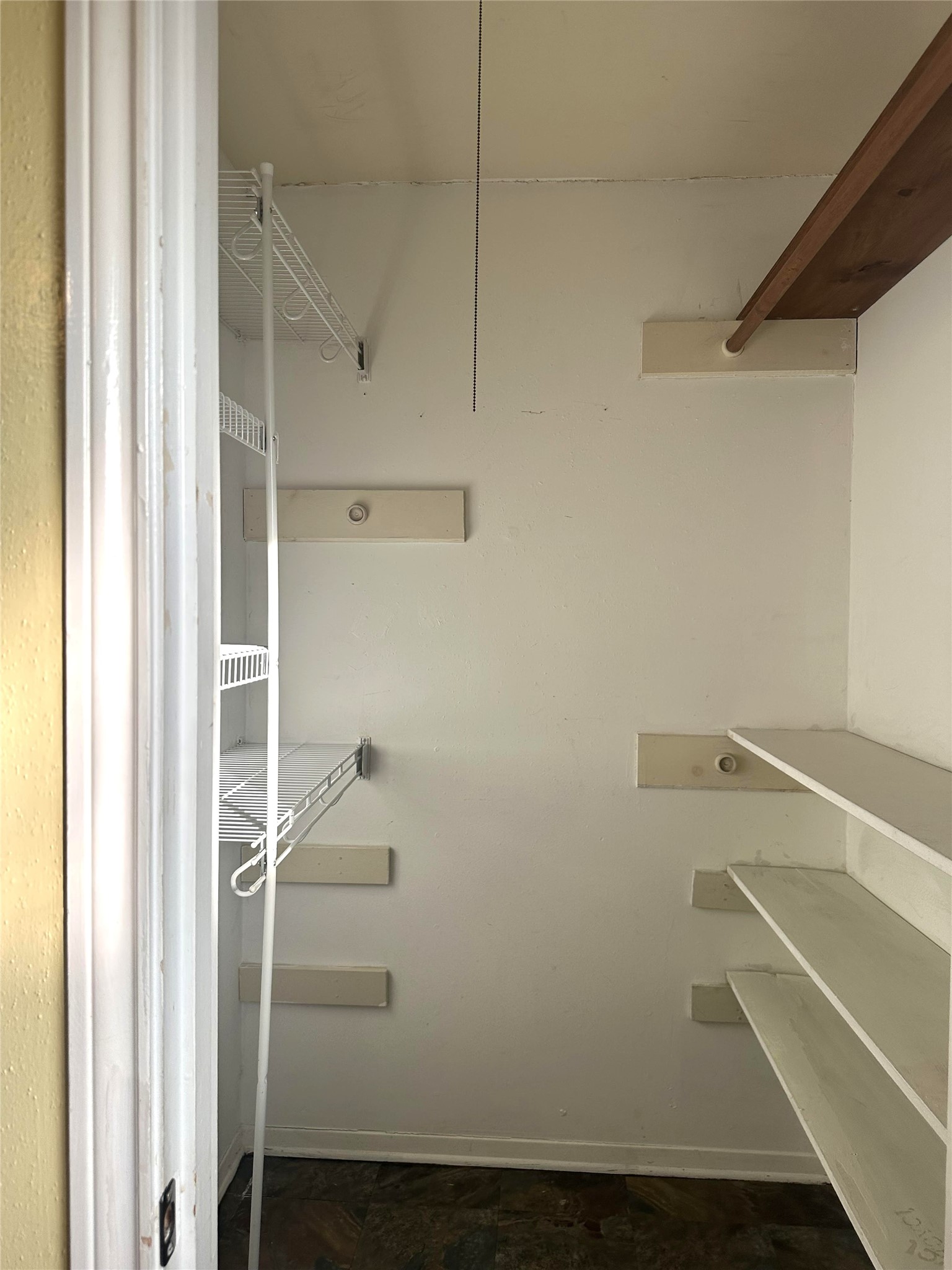 12331 Scarcella Lane Meadows Place, TX 77477 - Photo 8 of 13 walk-in closet with wire shelving on one side and wooden shelves on the other.