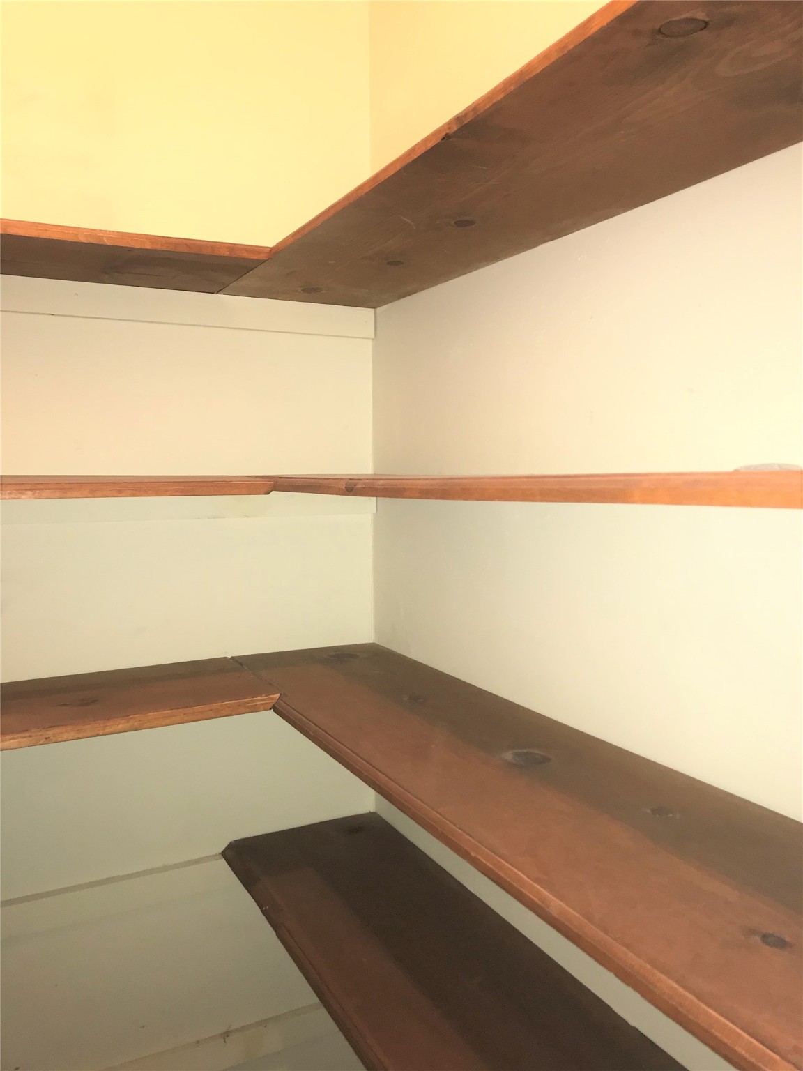 12331 Scarcella Lane Meadows Place, TX 77477 - Photo 10 of 13 A storage space with multiple wooden shelves.