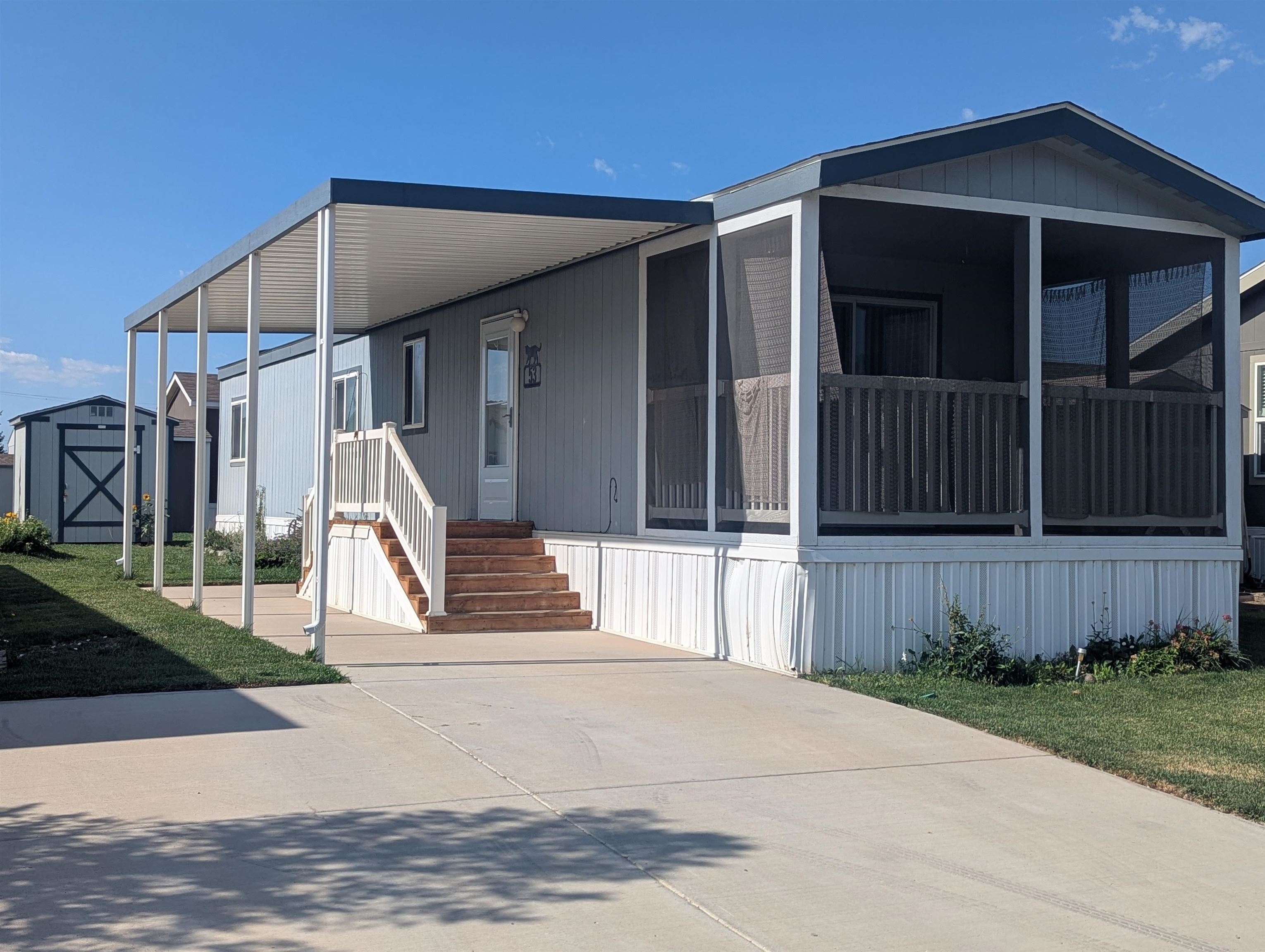 a view of a house with a small yard and wooden fence
