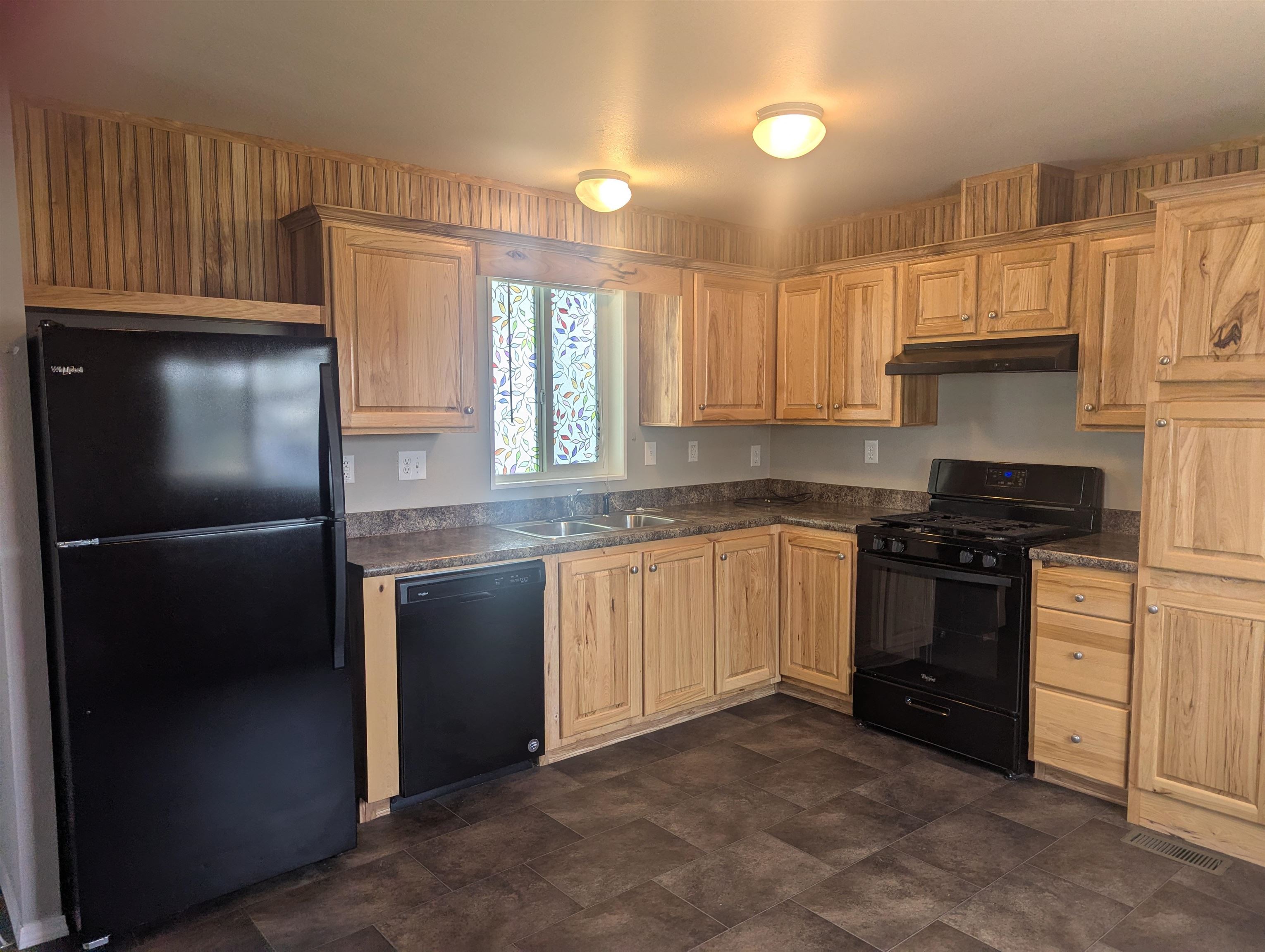 435 32 Road, Unit 53 Clifton, CO 81520 - Photo 11 of 24 a kitchen with granite countertop a refrigerator sink and cabinets