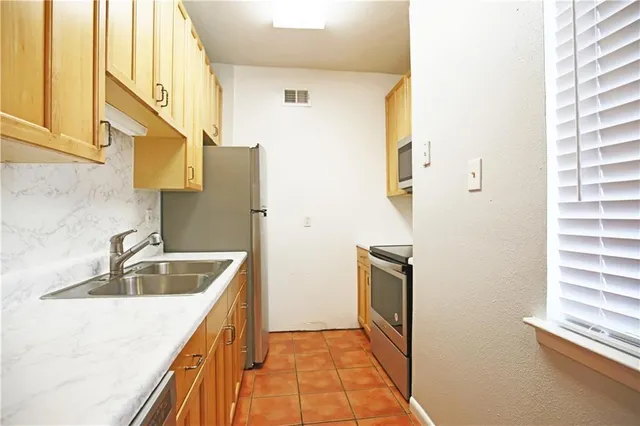 a kitchen with a sink and a refrigerator