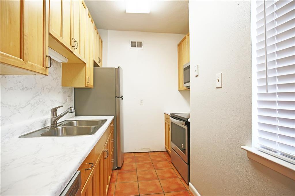 2408 Longview Street, Unit 212 Austin, TX 78705 - Photo 12 of 15 a kitchen with a sink and a refrigerator