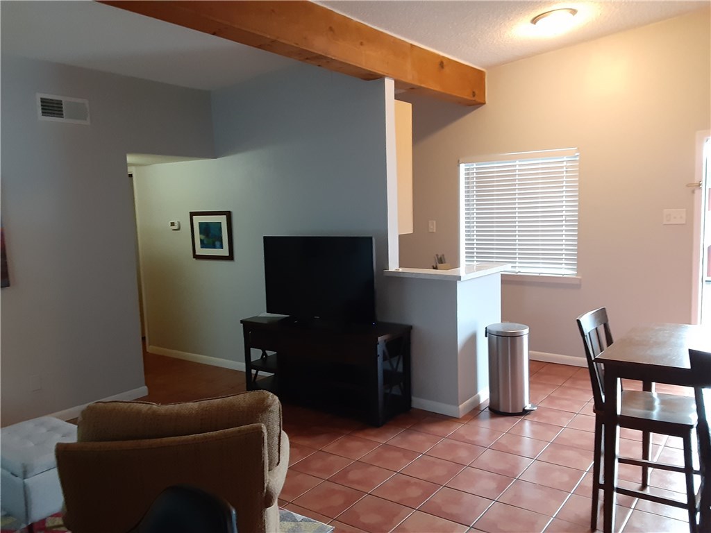 2408 Longview Street, Unit 212 Austin, TX 78705 - Photo 6 of 15 a living room with furniture and a flat screen tv