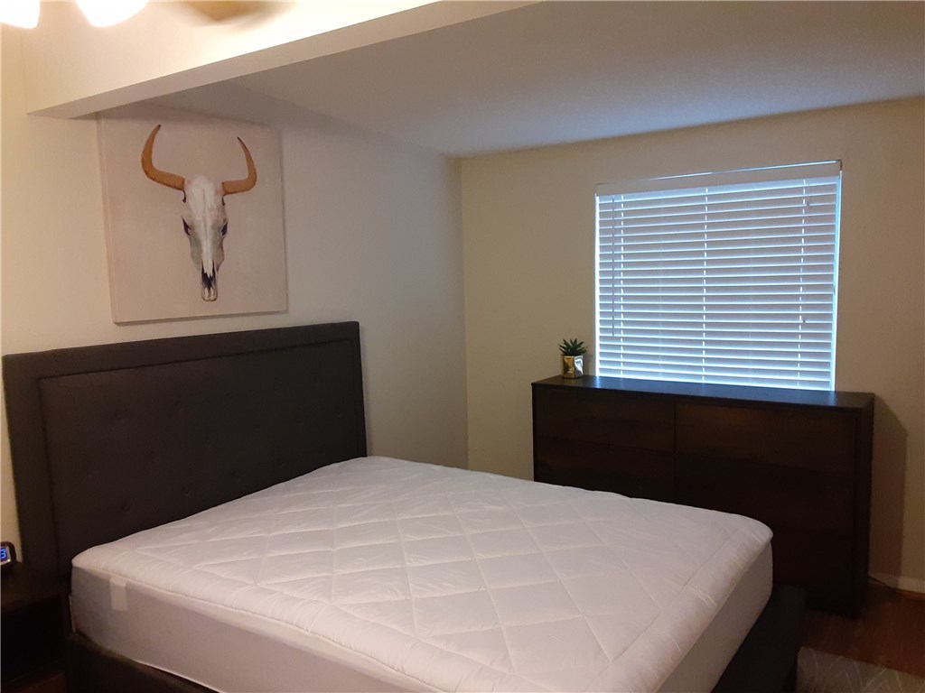 2408 Longview Street, Unit 212 Austin, TX 78705 - Photo 7 of 15 a bedroom with a bed and a window