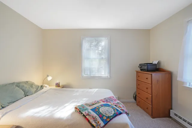 a bedroom with a bed and cabinets