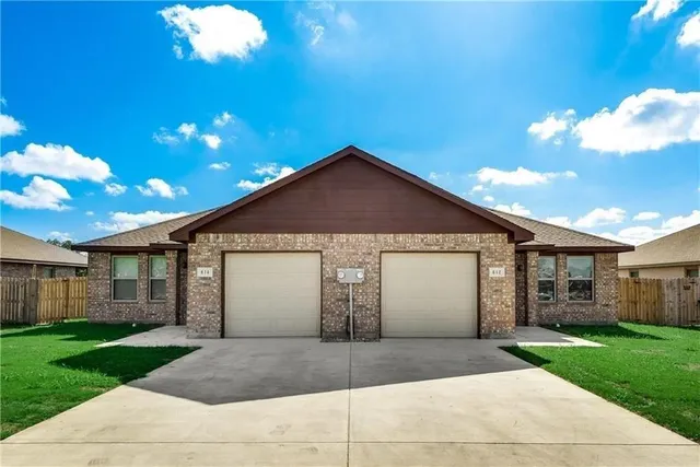 a view of a house with a yard and garage