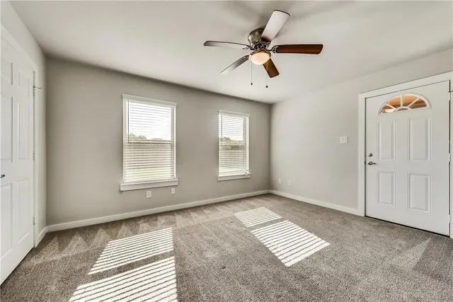 a view of an empty room with a window