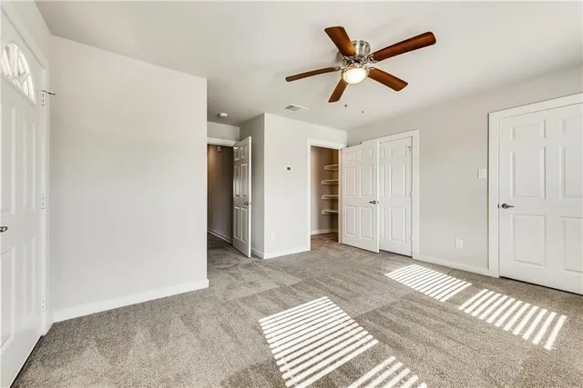 a view of a livingroom with a ceiling fan and wooden floor