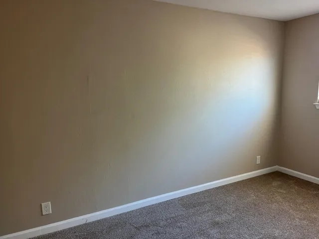 an empty room with sliding glass door