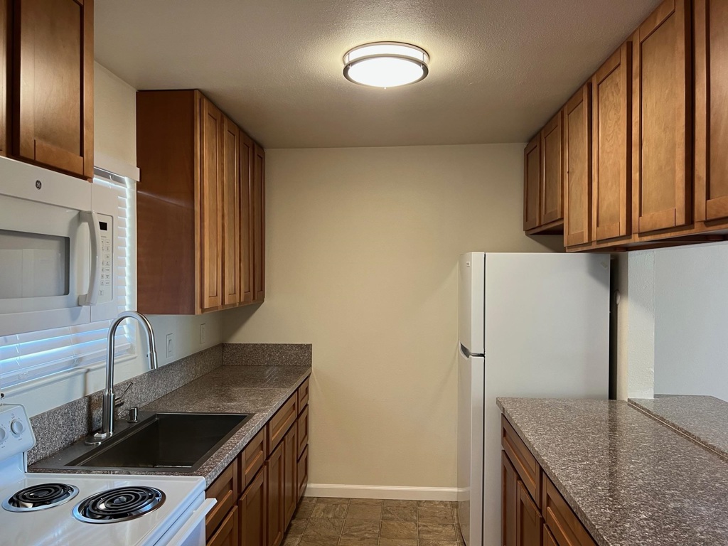 36976 Mulberry Street Newark, CA 94560 - Photo 4 of 29 a kitchen with stainless steel appliances granite countertop a refrigerator and a sink