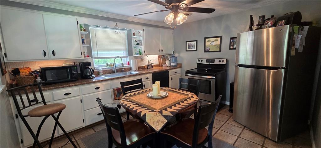 551 Muse-Bishop Road McDonald, PA 15057 - Photo 8 of 38 a kitchen with stainless steel appliances a refrigerator a stove a sink and chairs