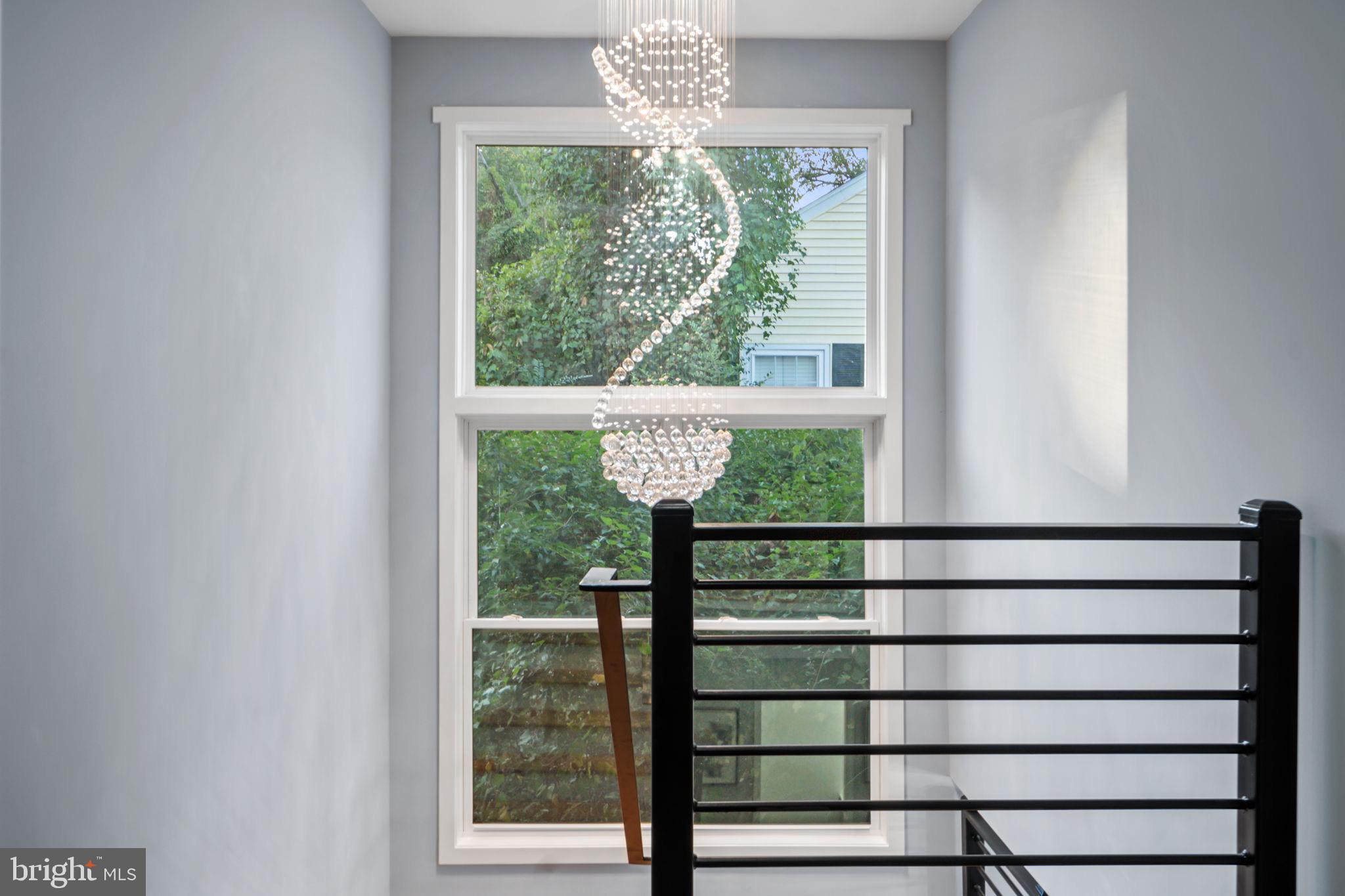 1611 Dayton Road Hyattsville, MD 20783 - Photo 37 of 54 Elegant staircase with modern chandelier.