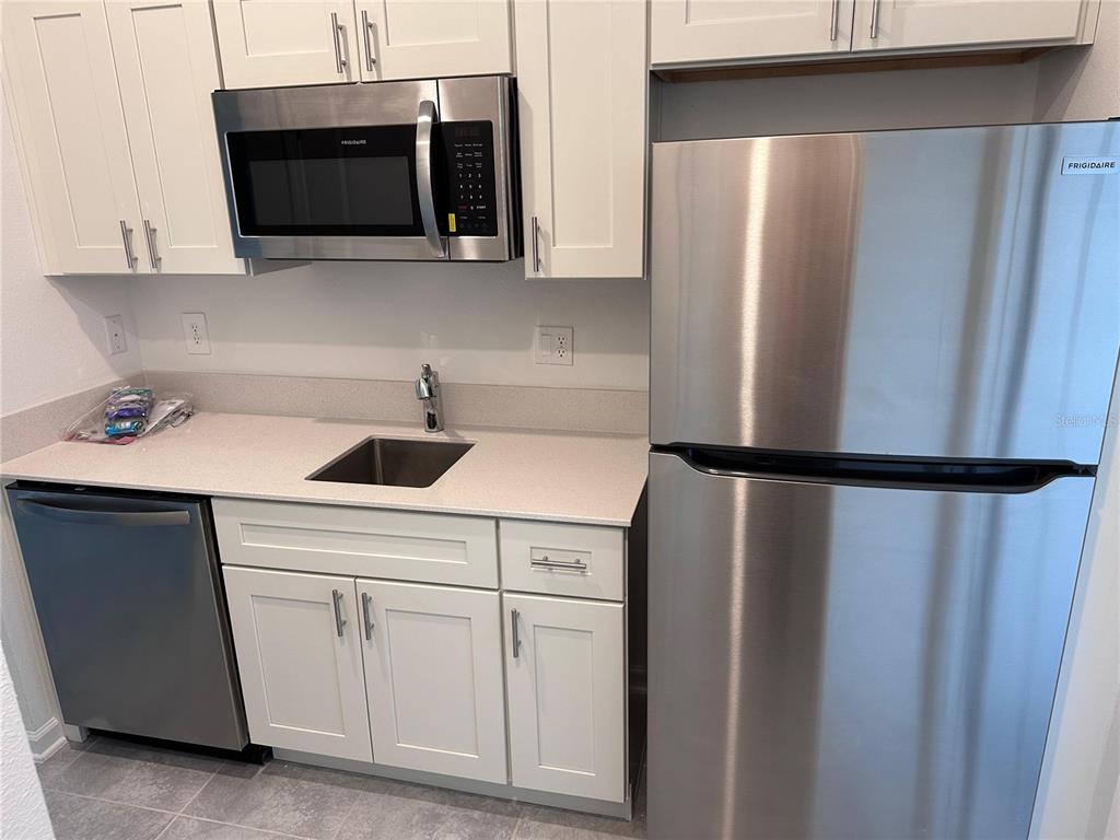 1760 Foreman Road Eagle Lake, FL 33839 - Photo 12 of 22 a kitchen with a refrigerator sink and microwave