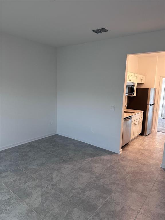 1760 Foreman Road Eagle Lake, FL 33839 - Photo 14 of 22 a view of an empty room and a kitchen
