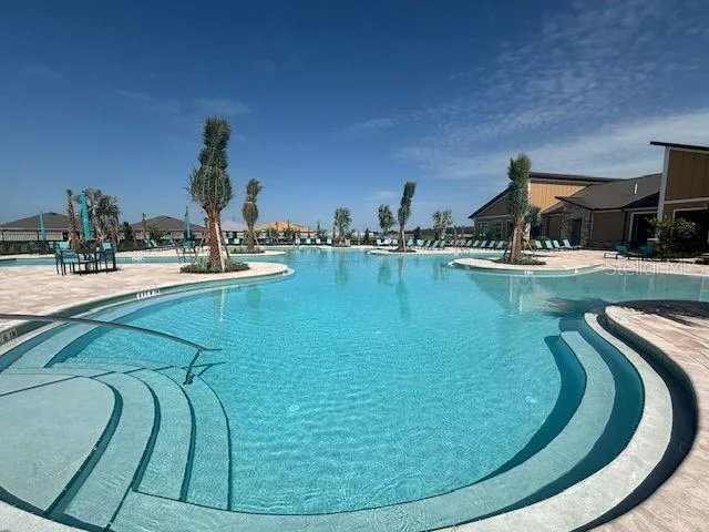 a view of a swimming pool with outdoor seating