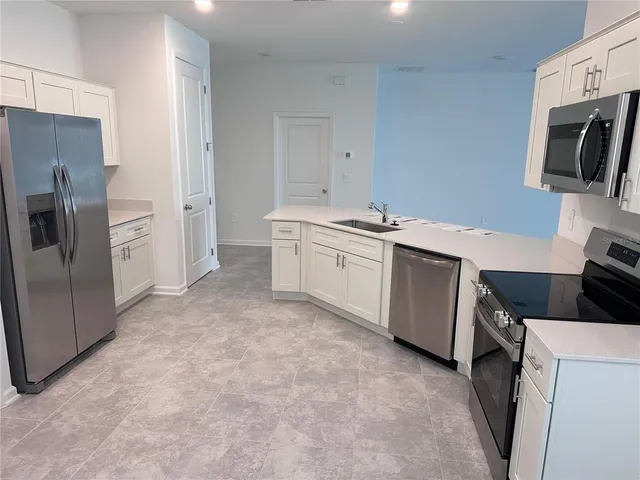 a kitchen with a sink stove and refrigerator
