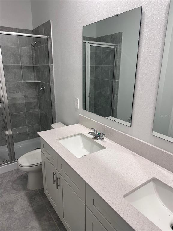 1760 Foreman Road Eagle Lake, FL 33839 - Photo 10 of 22 a bathroom with a sink a toilet and shower
