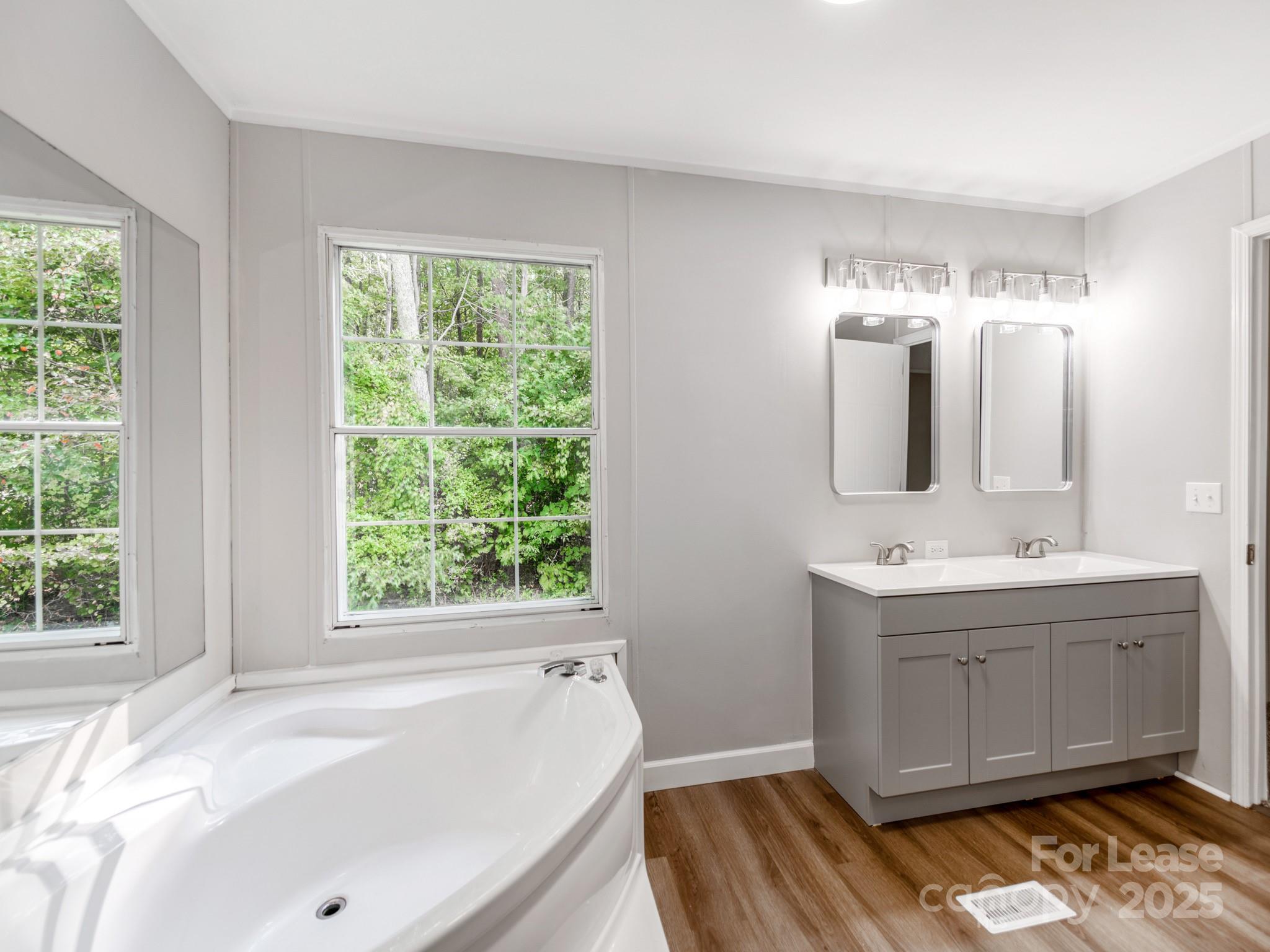 1219 Foxlaire Drive Denver, NC 28037 - Photo 12 of 30 a bathroom with a tub sink and mirror
