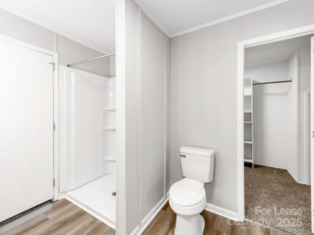 a view of walk in closet with empty racks