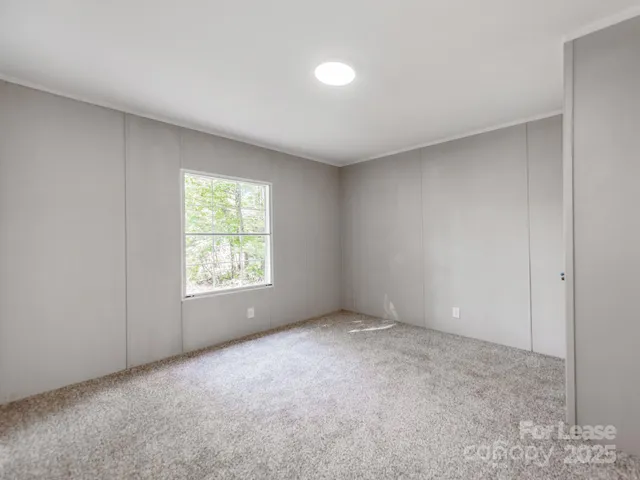 a view of an empty room and entryway